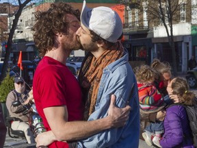 Couple Simon (right) and Sébastien (no last names given) embrace during a kiss-in in support of them at Place Simon-Valois in Montreal on Monday, May 9, 2016. The two men say they were beaten because they embraced outside a Hochelaga-Maisonneuve bar in Montreal. The event, organized by Gai Écoute and the Conseil québécois LGBT, was also a denouncement of homophobia.