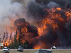 A giant fireball is seen as a wild fire rips through the forest 16 km south of Fort McMurray, Alta., on Highway 63 Saturday, May 7, 2016.