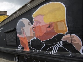 A graffito depicting Russian President Vladimir Putin, left, and Republican presidential candidate Donald Trump, is on the walls of a bar in the old town in Vilnius, Lithuania, Saturday, May 14, 2016.