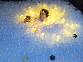 A participant takes a break in a plastic ball swimming pool at the C2 Montréal business conference on Wednesday, May 25, 2016, in Montreal.