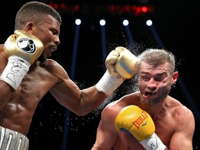 Lucian Bute of Canada (right) is punched by Badou Jack of Sweden in their WBC super middleweight championship bout at the DC Armory on April 30, 2016 in Washington, DC.