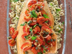 Rainbow trout fillets topped with a tomato-caper mixture are served over seasoned brown rice in this healthy recipe.