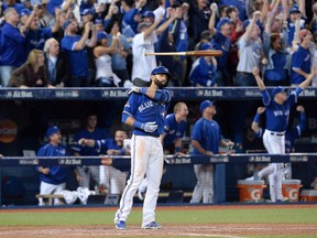 Toronto Blue Jays Jose Bautista flips his bat after hitting a three-run homer during seventh inning Game 5 American League Division Series Oct. 14, 2015.