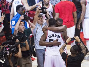 Toronto Raptors centre Bismack Biyombo (8) hugs forward Patrick Patterson (54) after defeating the Cleveland Cavaliers Monday, May 23, 2016.