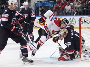 Connor McDavid of Canada collides with Keith Kinkaid of the U.S. at Ice Palace on May 21, 2016, in Moscow.