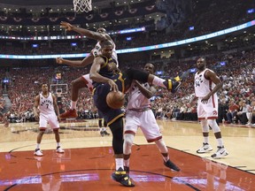 Cleveland Cavaliers guard Tristan Thompson (13) battles for a rebound against Toronto Raptors centre-forward Bismack Biyombo (8) and forward DeMarre Carroll (5) during third quarter Eastern Conference final NBA playoff basketball action in Toronto on Friday, May 27, 2016.