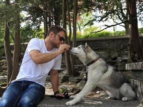 Mako the Siberian Husky puppy and owner Will Allen hanging out just a few steps from the dog run at Murray Hill Park. It's treat time, compensation after a very long walk and some excellent behaviour in the pen.
(Photo Paul Labonté)