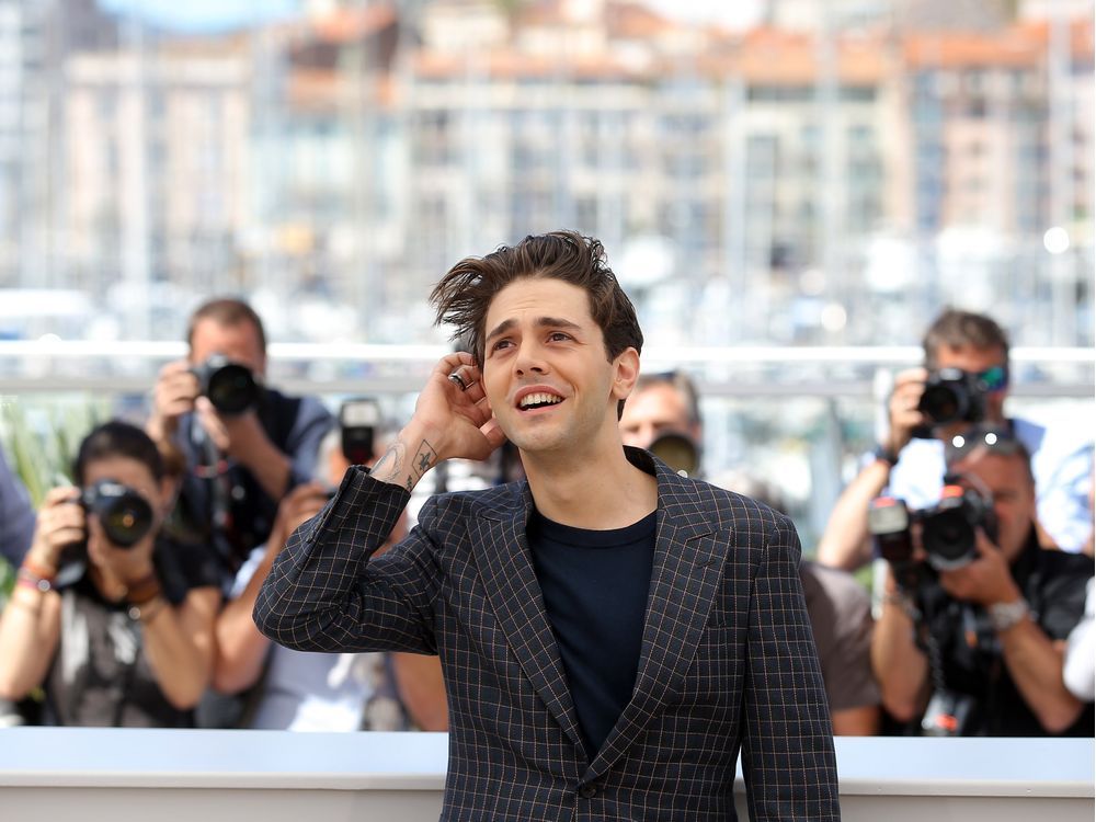 Director Xavier Dolan poses for photographers at the See The World