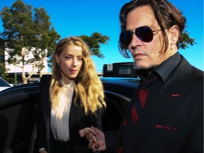 This file photo taken on April 17, 2016 shows Johnny Depp and Amber Heard as they arrive at a court in the Gold Coast, Australia. Heard has filed for divorce, citing irreconcilable differences.