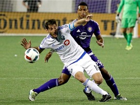 Montreal Impact's Ignacio Piatti, left, moves the ball away from Orlando City's Tommy Redding during the second half of an MLS soccer game, Saturday, May 21, 2016, in Orlando, Fla. Orlando won 2-1.
