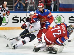 Russia's defender Vyacheslav Voinov vies with U.S. forward Frank Vatrano  in fromt of Russia's goalie Sergei Bobrovski during the bronze medal game Russia vs USA at the 2016 IIHF Ice Hockey World Championship in Moscow on May 22, 2016.