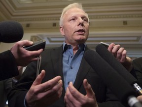 Parti Québécois MNA Jean-François Lisée responds to reporters' questions before entering a party caucus meeting, Tuesday, May 10, 2016 at the legislature in Quebec City.