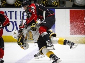 Brandon Wheat Kings' Jordan Thomson, left, gets slammed by Rouyn-Noranda Huskies' Jeremy Lauzon during first period CHL Memorial Cup hockey action in Red Deer, Saturday, May 21, 2016.