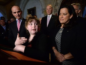 Charlie Lowthian-Rickert, who is transgender, speaks along side Justice Minister Jody Wilson-Raybould, right, as she makes an announcement in the foyer of the house of commons on Parliament Hill in Ottawa on Tuesday, May 17, 2016, regarding legislation on gender identity and gender expression.