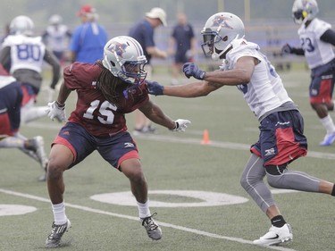 Alouettes rookie Ethan Davis, left, battling B. J. Cunningham at training camp,  started all 24 games in his final two seasons at Troy State University. He had 77 tackles over four seasons, one interception and two forced fumbles.