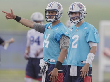 Quarterbacks Dante Djan, left, and Drew Burko, right, take part in the Montreal Alouettes training camp at Bishop's University in Lennoxville on Sunday, May 29, 2016.