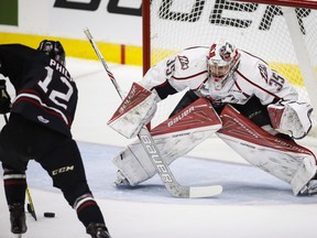 Rouyn-Noranda Huskies goalie Chase Marchand, right, is pressured by Red Deer Rebels' Luke Philp during first period CHL Memorial Cup semi-final hockey action in Red Deer, Friday, May 27, 2016.