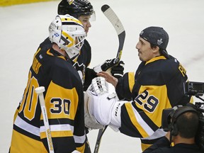 Pittsburgh Penguins goalie Marc-André Fleury (29) congratulates Pittsburgh Penguins goalie Matt Murray (30) after the Penguins defeated the Washington Capitals in Game 3 in an NHL hockey Stanley Cup Eastern Conference semifinals in Pittsburgh, Monday, May 2, 2016.