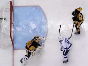 Tampa Bay Lightning's Tyler Johnson (9) gets the puck past Pittsburgh Penguins goalie Marc-Andre Fleury (29) with Sidney Crosby (87) defending for the game winning goal in overtime during Game 5 of the NHL hockey Stanley Cup Eastern Conference finals, Sunday, May 22, 2016 in Pittsburgh.
