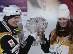 Mikael Kingsbury, left, and Chloe Dufour-Lapointe display their Crystal Globe trophies after the World Cup freestyle skiing final event in Moscow on March 5, 2016. It's the first time Canada has claimed both men's and women's trophies.