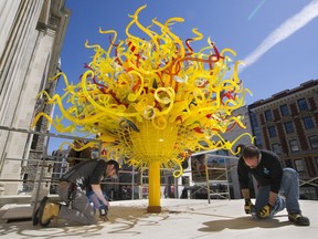 The Montreal Museum of Fine Arts installs the sculpture, The Sun, by U.S. glass blowing artist Dale Chihuly, on the front steps of the Michal and Renata Hornstein Pavilion of the museum, Thursday, April 16, 2015.