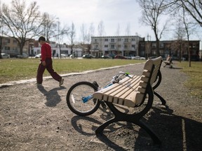 A child walks past a bicycle at the Sinclair-Laird school park near the corner of Liege and Wiseman Sts. in Montreal on Saturday, April 16, 2016. The English Montreal School Board was considering using the land to build a daycare. (Dario Ayala / Montreal Gazette)