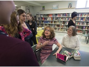 Author Monique Polak, with open book in the centre, speaks with students who participated in her novel for teens called Leggings Revolt (about teens protesting a school dress code) at St. Thomas High School in Pointe-Claire on Friday, April 29, 2016. (Peter McCabe / MONTREAL GAZETTE)