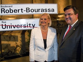 Robert Bourassa's wife, Andrée Bourassa, left , is standing with Montreal Mayor Denis Coderre during a ceremony at city hall in 2014. to honour the former premier with a street name. The city of Montreal has had a website since 2007 where residents can peruse the origin of 6,000 street names. The site is available only in French.
