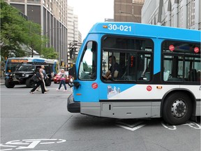 An STM bus turns off University St. onto de Maisonneuve Blvd. in Montreal on Thursday, Aug. 28, 2014.