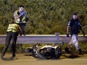 Police inspect the scene of a motorcycle accident in this file photo: 49 motorcyclists died in road accidents in Quebec in 2018.