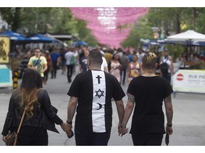 Pedestrians walk along Ste-Catherine St. in Montreal's Gay Village on Friday June 19, 2015.