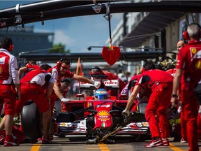 Ferrari F1 driver Fernando Alonso of Spain arrives at the pits during the second free practice session in 2014.
