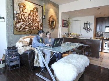 Judith Lessard and Wallace Lee in their penthouse apartment in downtown Montreal does triple duty as a dining room and office. (John Mahoney / MONTREAL GAZETTE)