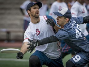 Montreal Royal Felix-Antoine Daigle right, tries to block the pass by D.C. Breeze player during their Ultimate match on Sunday.