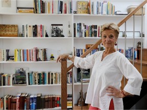 Lies Ouwerkerk stands next to one of several book shelves in her condo. (Allen McInnis / MONTREAL GAZETTE)