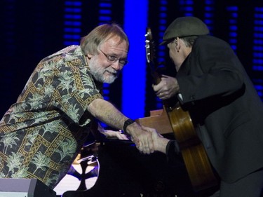 James Taylor (right) paid homage his accompanying band, including pianist Jim Cox, at the Bell Centre in Montreal on Friday, May 13, 2016.