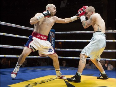 Super lightweight Mathieu Germain, in white trunks, lands a punch against Adam Mate at the second edition of the Fight Club Series at Metropolis in Montreal, Friday, May 13, 2016.