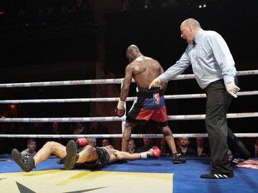 Super middleweight Schiller "Batman" Hyppolite, in black trunks with Haitian flag, knocks out Pablo Daniel Zamora, (in black trunks) in the fifth round at the second edition of the Fight Club Series at Metropolis in Montreal, Friday, May 13, 2016.