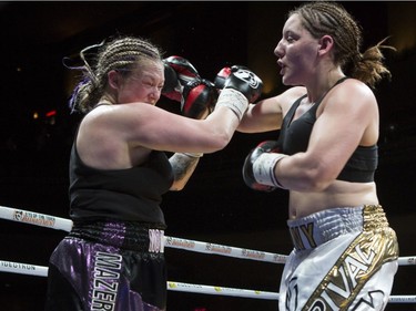 Vanessa Lepage Joanisse, in white and gold trunks,lands a punch against Annie Mazerolle at the second edition of the Fight Club Series at Metropolis in Montreal, Friday, May 13, 2016.