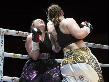 Vanessa Lepage Joanisse, in white and gold trunks,lands a punch against Annie Mazerolle at the second edition of the Fight Club Series at Metropolis in Montreal, Friday, May 13, 2016.