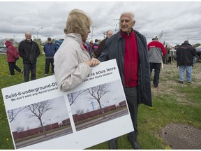 Dollard-des-Ormeaux Mayor Ed Janiszewski, right, speaks with a resident who came out to protest the proposed installation of Hydro-Quebec's 315 kV transmission line and the redevelopment of the St-Jean substation on Sunday, May 16, 2016.  (Peter McCabe / MONTREAL GAZETTE)