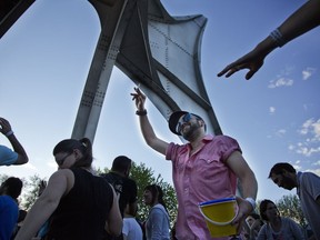 Geoffrey Bodenan dances at Piknic Electronik festival at Parc Jean-Drapeau on  May 19, 2014, under the striking arches of Alexander Calder's metal L'homme sculpture.