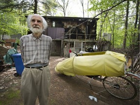 Peder Mortensen, 81, beside his bicycle, outside his self built home in Vaudreuil-Dorion. (Peter McCabe / MONTREAL GAZETTE)