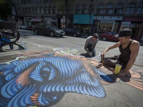 Artists Jason Botkin foreground and Luc Antoie paint the sidewalk and road as they participate in the beautification of St-Laurent Blvd. between  Sherbrooke and Mont Royal in Montreal on Sunday May 22, 2016.