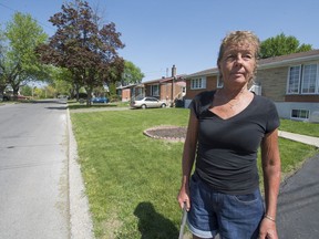 Patricia Scott stands in front of her home on Archambault Street in Vaudreuil-Dorion on Monday, May 23, 2016. The city of Vaudreuil has told homeowners that it will be planting trees along the street, a move that they had done many years ago. Many homeowners ended up with all sorts of problems due to the roots of these trees breaking underground pipes. (Peter McCabe / MONTREAL GAZETTE) ORG XMIT: 56267
