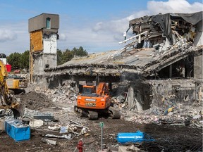 A  demolition crew tears down part of the old Merck Frosst complex in Kirkland, on Tuesday, May 3, 2016. (Dave Sidaway / MONTREAL GAZETTE)