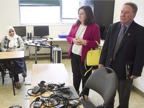 Senator and chair of the Standing Senate Committee on Human Rights, Jim Munson, right, and deputy chair, Conservative Senator Salma Ataullahjan, speak to refugees during walking tour of the Centre d'Accueil et de Reference sociale et economique pour immigrants in St-Laurent on Tuesday May 31, 2016.