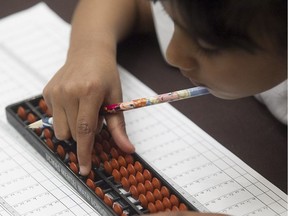 Six year-old Srijamsan Sanchiana uses her abacus during exam at the Quebec Regional UCMAS Mental Math Competition held in Montreal's Pointe-Claire Holiday Inn on Sunday, May 8, 2016. (Pierre Obendrauf / MONTREAL GAZETTE)