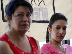 Gilda Lakatos, right, listens as her mother, Katalin Lakatos, describes the harassment that led to her son taking his own life. Lakatos was speaking at a Solidarity Across Borders press conference in Montreal on Monday May 9, 2016.