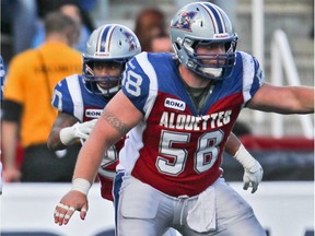 Former Laval Rouge et Or offensive-lineman Luc Brodeur-Jordain, front, holds off Argonauts during 2012 game at Molson Stadium.